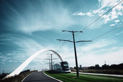 Tram on road against sky