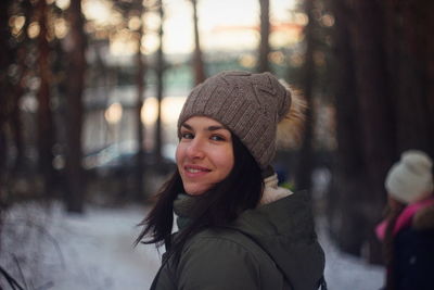 Portrait of young woman in hat during winter