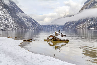 Scenic view of lake and snowcapped mountains against sky