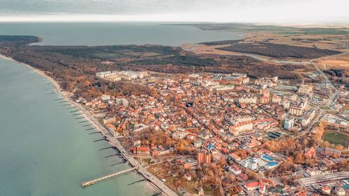 High angle view of sea and buildings against sky