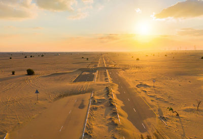 Scenic view of desert against sky during sunset