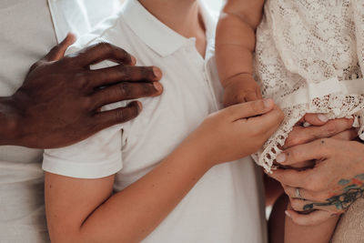 Midsection of couple holding hands