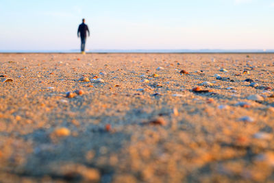 Full length of man on beach against sky