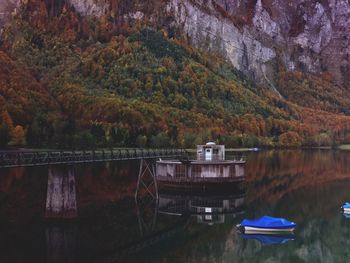 Scenic view of lake by trees against mountain