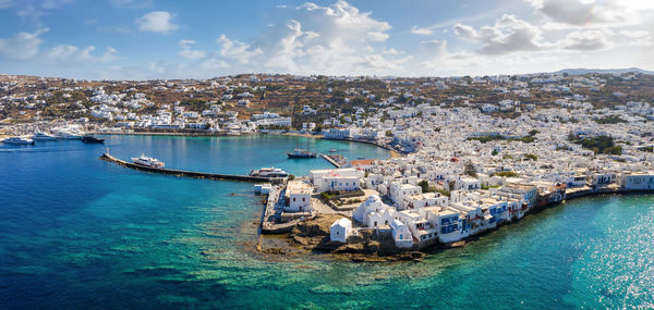 High angle view of sailboats moored in sea against sky