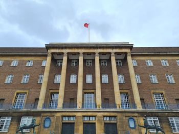 Low angle view of building against cloudy sky