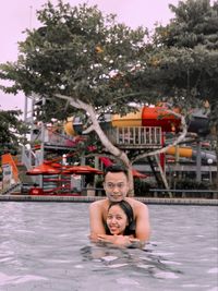 Portrait of a smiling young woman swimming pool