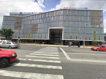 Vehicles on road against buildings in city