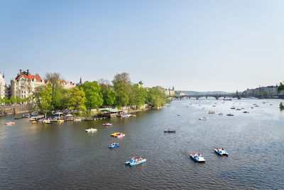 Aerial view of boats in river against sky