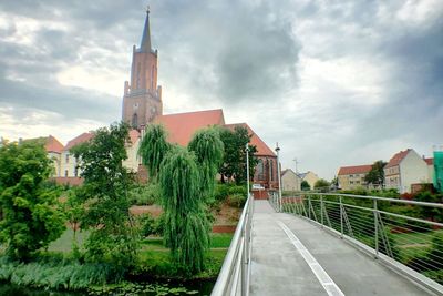 Buildings against cloudy sky