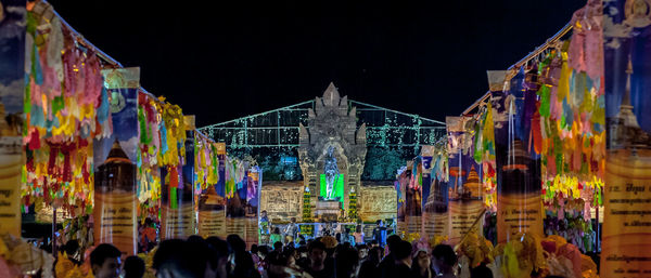 Group of people in front of building at night