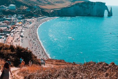 Group of people at beach by mountain