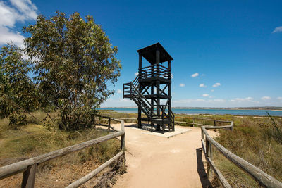 Lifeguard hut on beach against sky