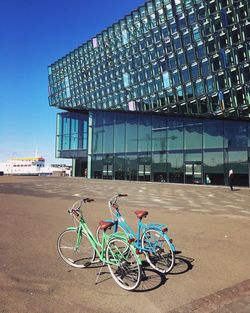 Bicycles on beach against clear sky