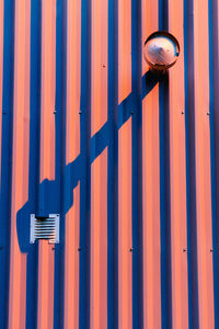 Close-up of metal gate against blue sky