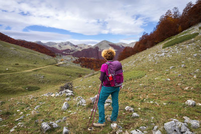 Rear view of woman walking on mountain