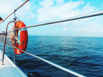 Lifebelt in boat on sea against sky