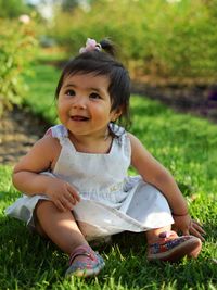 Portrait of a girl sitting on field