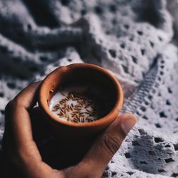 Close-up of hand holding tea cup