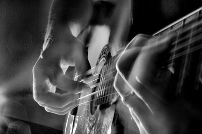 Close-up of hands playing guitar