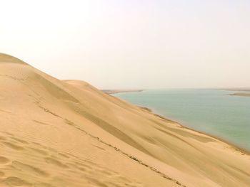 Scenic view of beach against clear sky