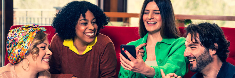 Portrait of smiling friends enjoying at home