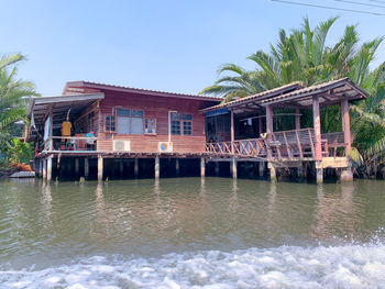 Building by sea against clear sky