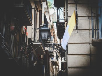 Clothes drying on alley amidst buildings in city