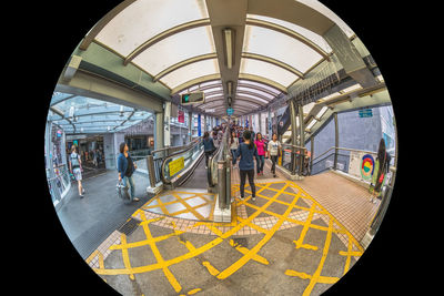 People on railroad station platform seen through glass window