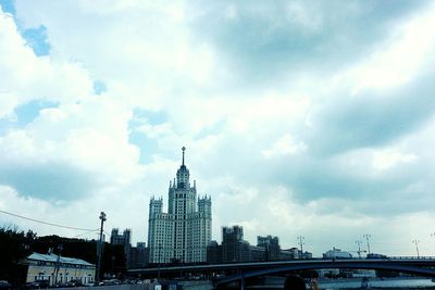 Low angle view of eiffel tower against cloudy sky