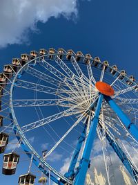 Low angle view of ferris wheel against blue sky