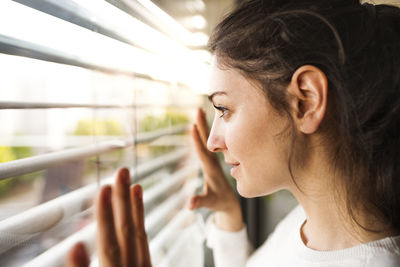 Woman at home looking out of the window