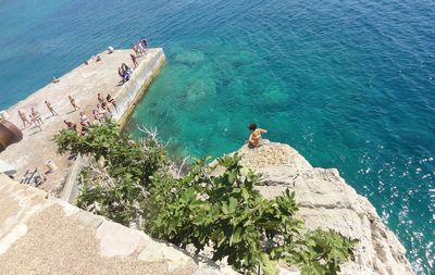 High angle view of people on pier over sea