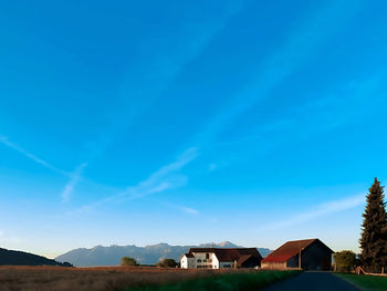 Houses and buildings against blue sky