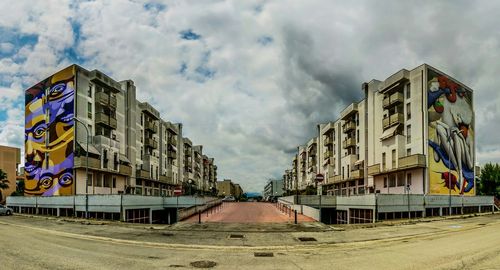 Buildings against cloudy sky