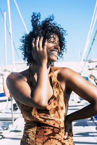 Happy woman with curly hair on boat