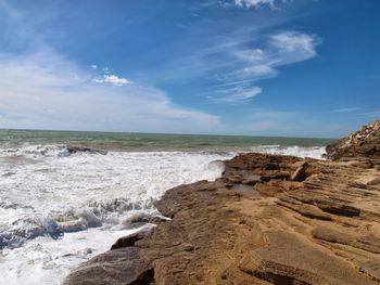 Scenic view of beach against blue sky