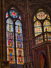 Low angle view of ornate glass window in building