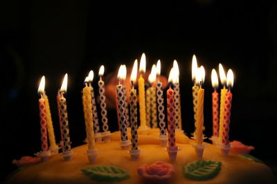 Close-up of burning candles on birthday cake