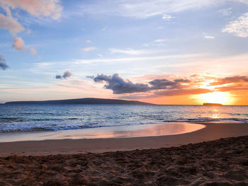 Scenic view of beach against sky during sunset