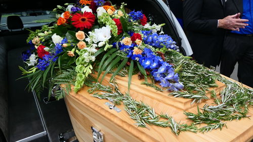 Close-up of decorated coffin during funeral