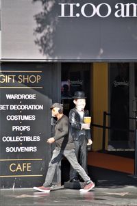 People standing on sign in city