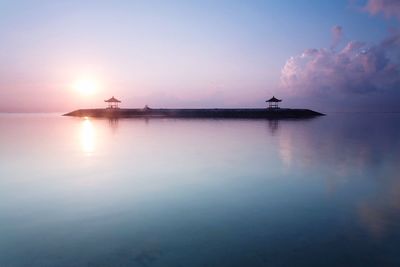 Silhouette boat in sea against sky during sunset