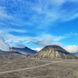 Scenic view of mountains against cloudy sky