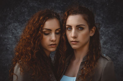 Portrait of siblings against wall