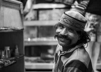 Portrait of smiling man wearing traditional cap