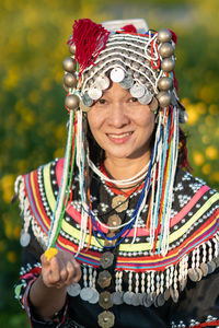 Portrait of smiling woman in traditional clothing standing at farm