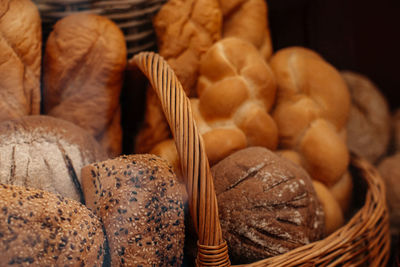 Fresh baked multigrain bread in a wicker basket in a baked goods store