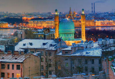 High angle view of illuminated buildings in city at dusk