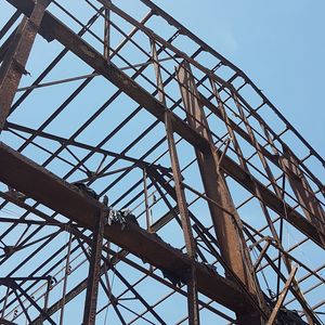 Low angle view of abandoned construction against clear blue sky